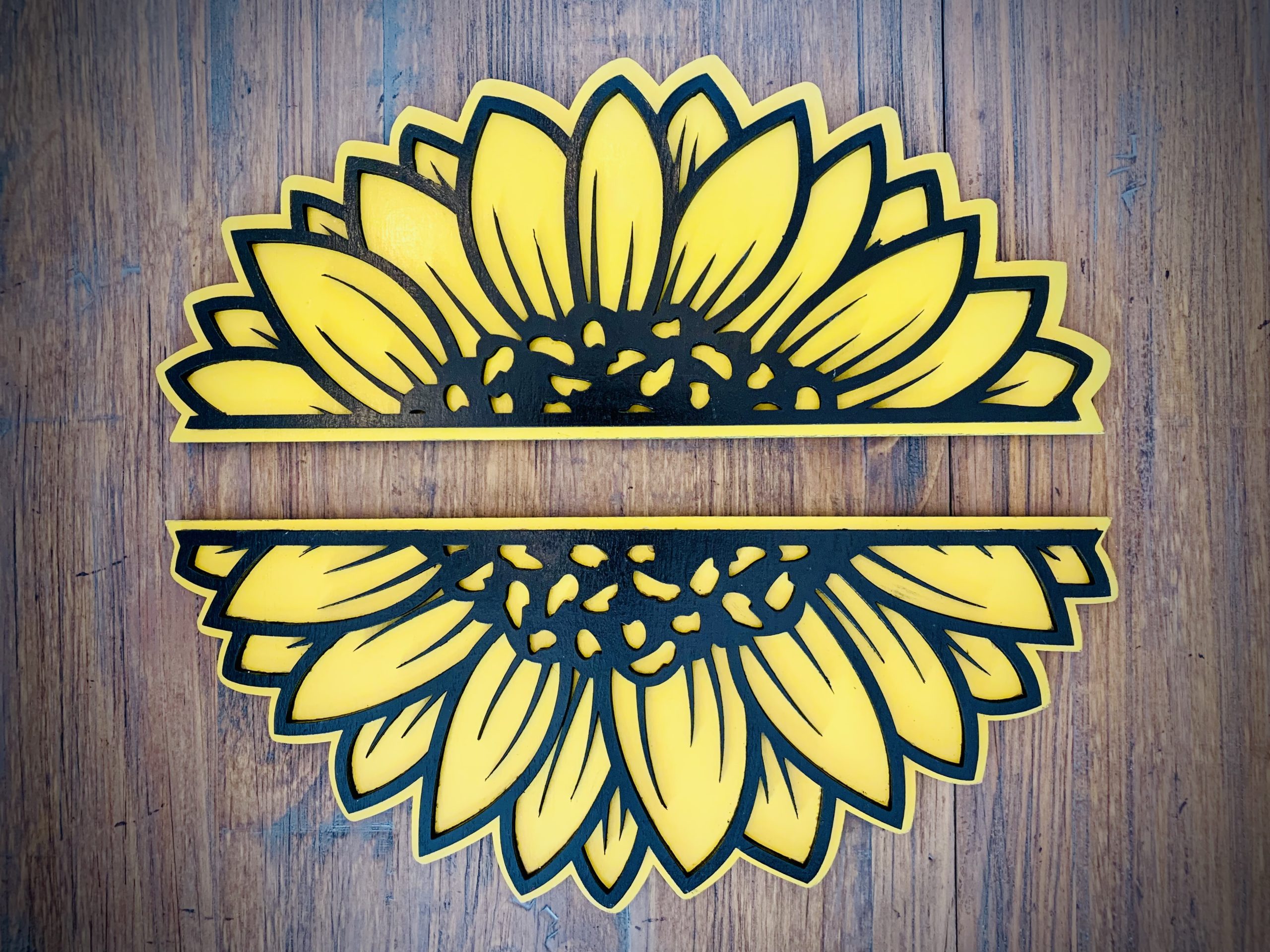 Interchangeable EverWreath sunflower plate set with layered yellow sunflower petals on a wood background
