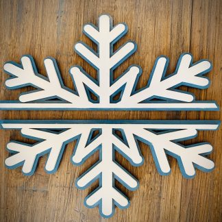 Interchangeable EverWreath winter plate set with a layered white snowflake design on a wood background