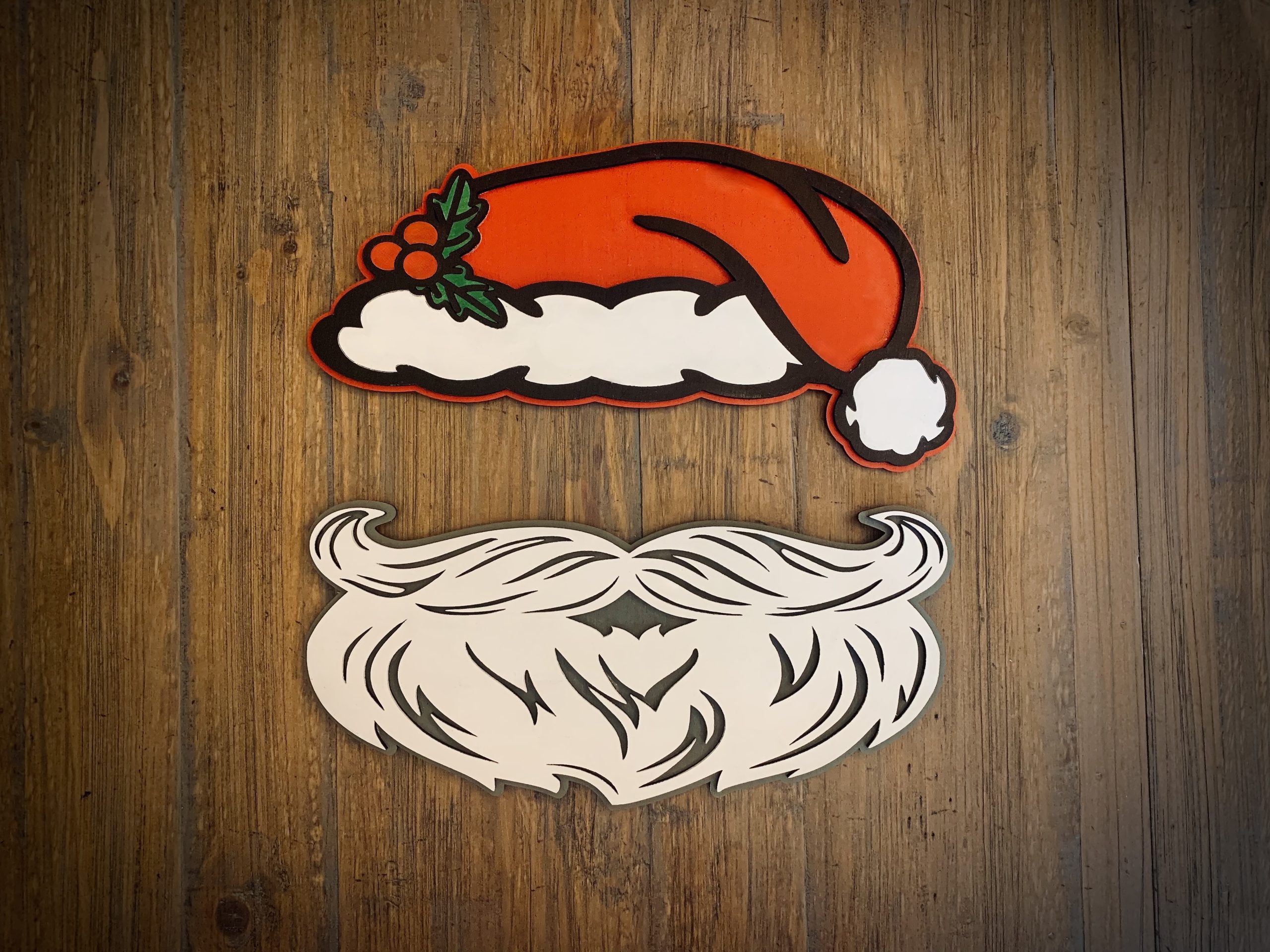 Interchangeable EverWreath Christmas plate set with a red Santa hat and white Santa beard pieces on a wood background