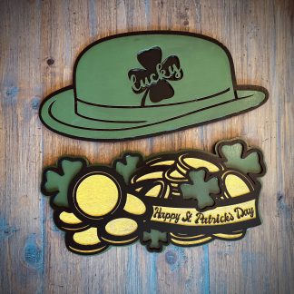 Interchangeable EverWreath St. Patrick’s Day plate set with a green lucky hat, shamrocks, gold coins, and a “Happy St. Patrick’s Day” banner on a wood background
