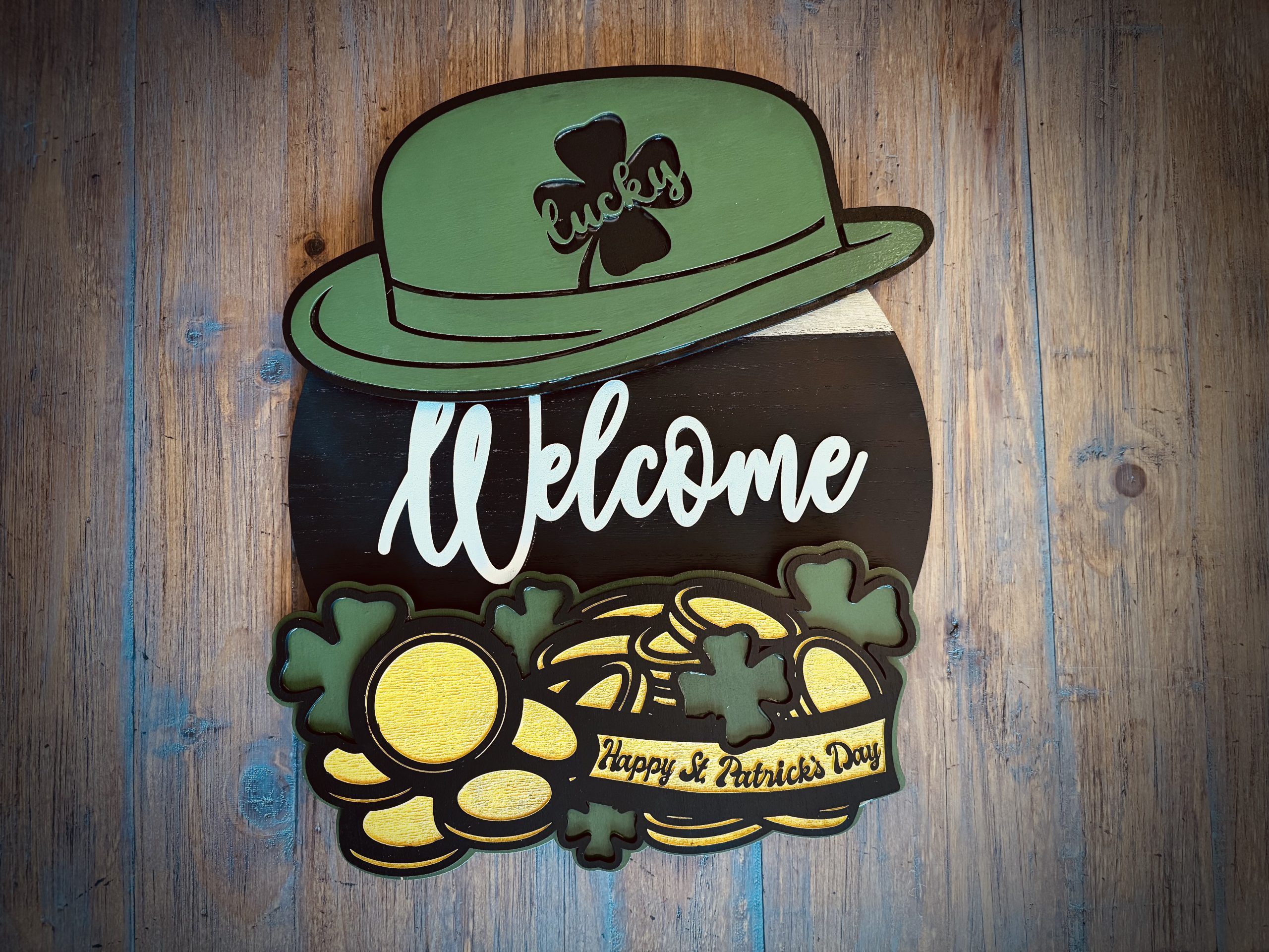 EverWreath interchangeable wooden welcome sign with St. Patrick’s Day attachments including a green hat, shamrocks, gold coins, and a “Happy St. Patrick’s Day” banner