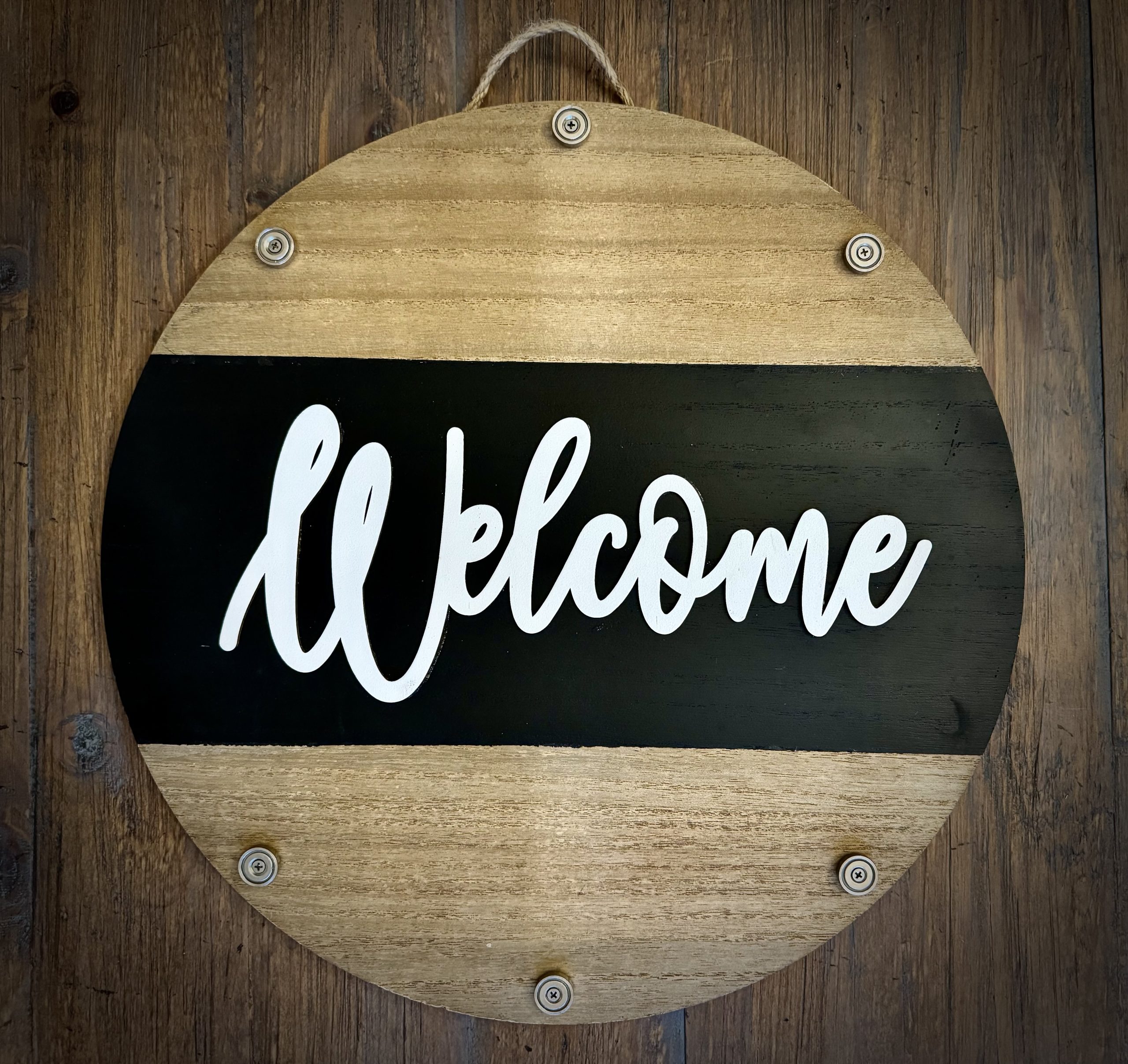 Round wooden EverWreath base welcome sign with natural wood finish, black center band, and white “Welcome” lettering