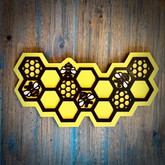 Interchangeable EverWreath honey bee plate with yellow honeycomb design and bee details on a wood background