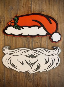 Interchangeable EverWreath Christmas plate set with a red Santa hat and white Santa beard pieces on a wood background