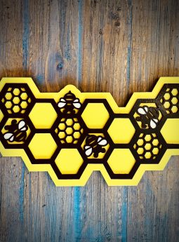 Interchangeable EverWreath honey bee plate with yellow honeycomb design and bee details on a wood background