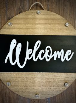 Round wooden EverWreath base welcome sign with natural wood finish, black center band, and white “Welcome” lettering