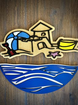 Interchangeable EverWreath beach-themed plate set with a sand castle, beach umbrella, bucket, starfish, and blue wave base pieces